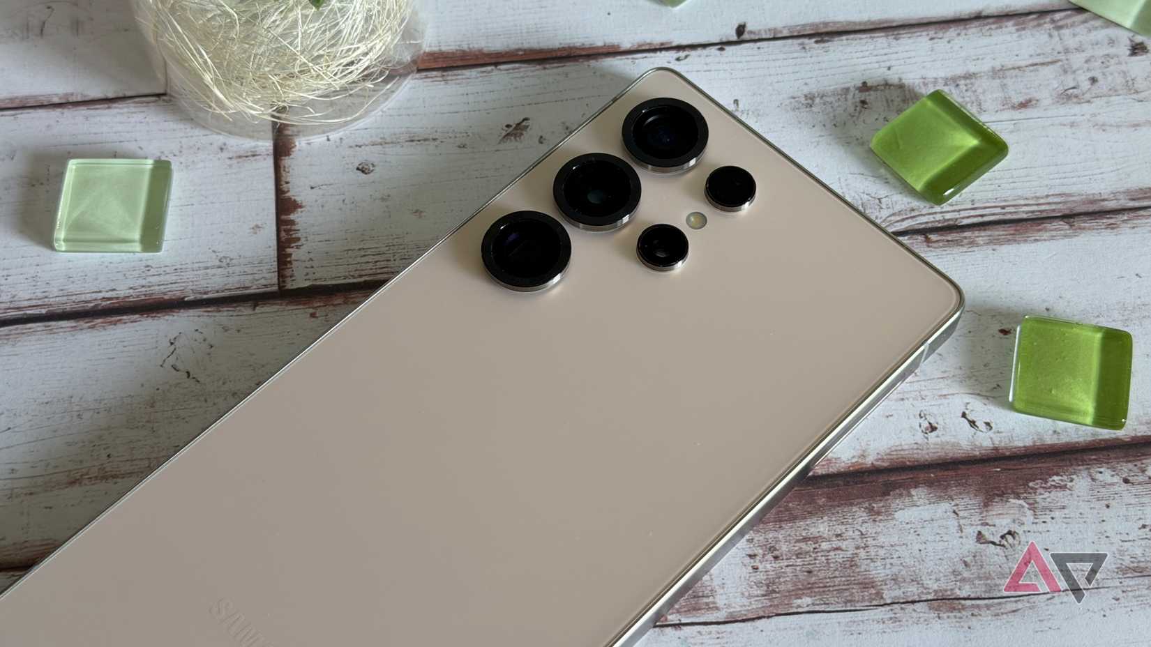 a phone displaying the google home app on a green mat next to pliers, wire, a raspberry pi, and a white box