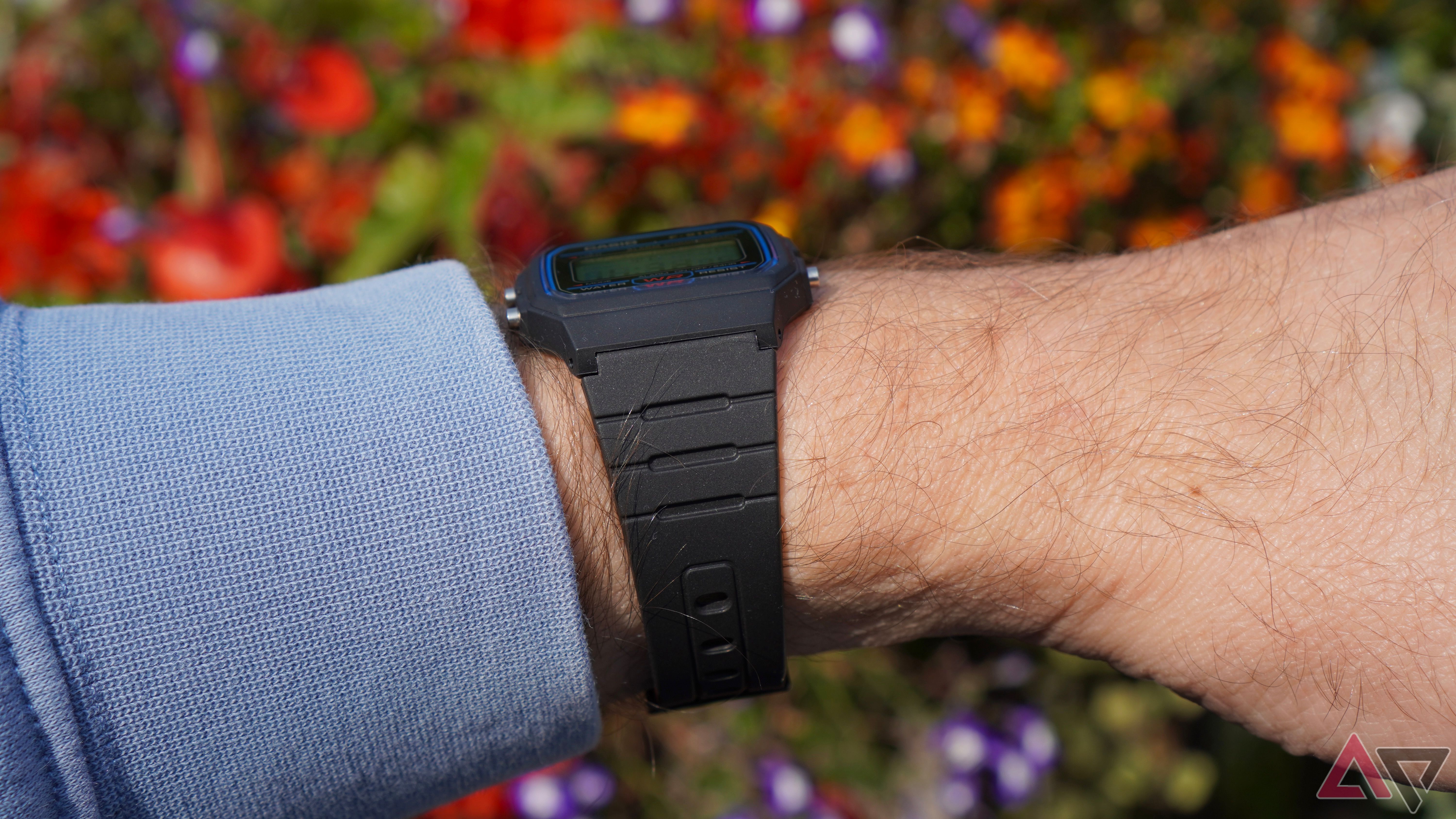 The side of the Casio F91W on a person's wrist