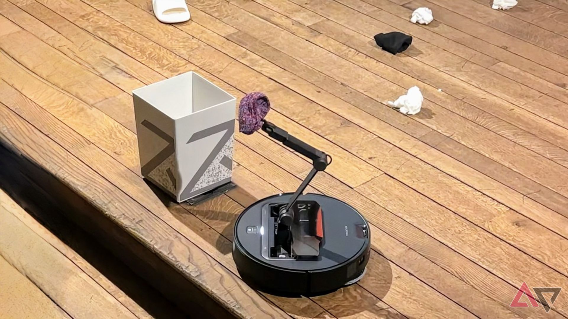 Roborock Saros Z70 carrying a sock to the bin