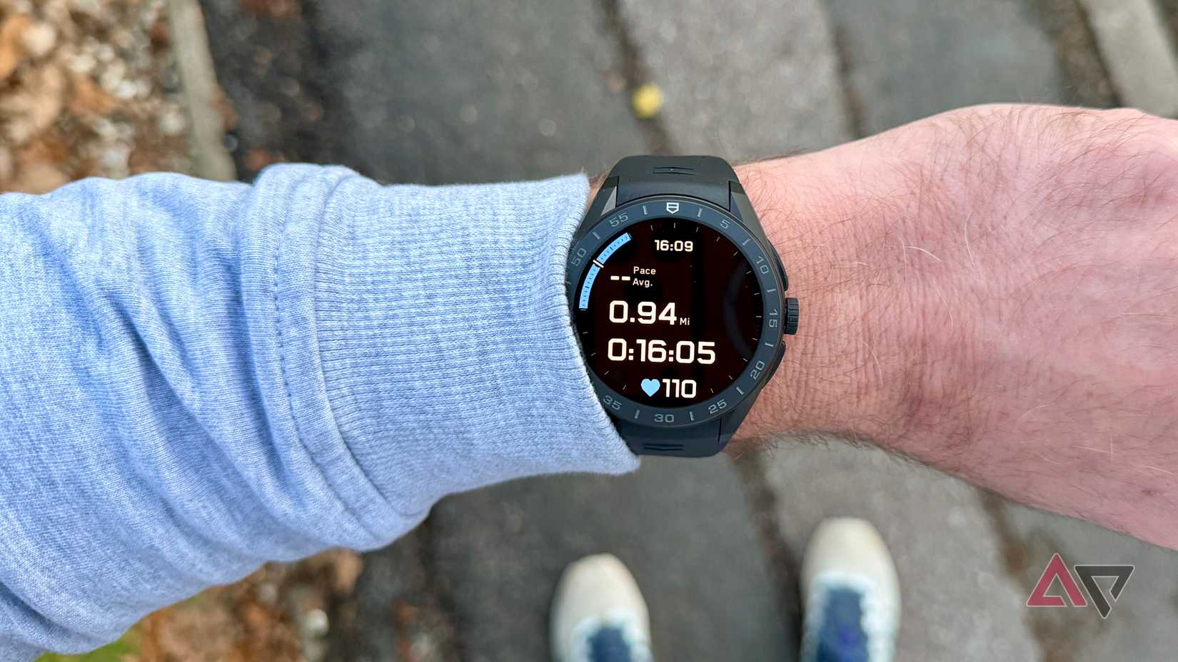 Wearing a Fitbit Versa 4 while stretching.