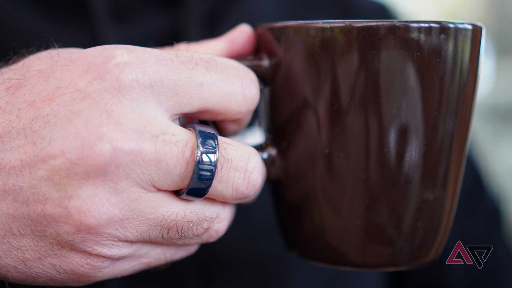 Samsung Galaxy Tab S10 Ultra showing home screen sitting on stump with dog spying