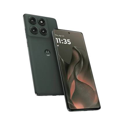 A man wearing a coat and scarf stands outside holding a phone