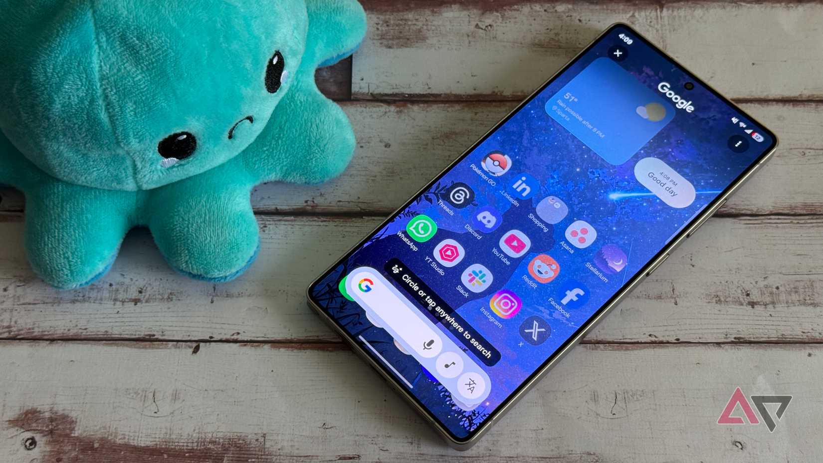 A person using circle to search on a phone over a yellow-orange background