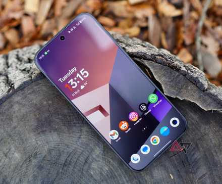 Samsung Galaxy Tab S10 Ultra showing home screen sitting on stump with dog spying