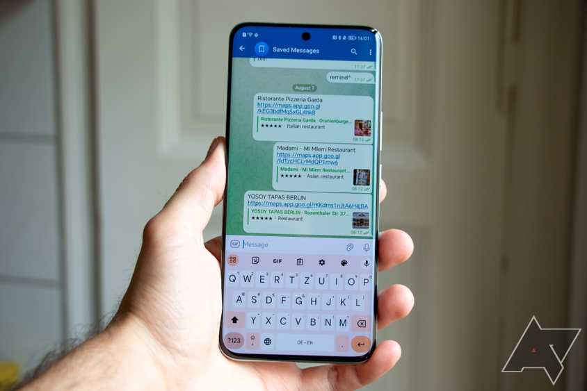 The Google Pixel Watch 2 next to the Google Pixel Watch 1 on a faux leather watch stand