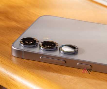 a phone displaying a ruler app next to a plastic ruler and calipers on a green mat