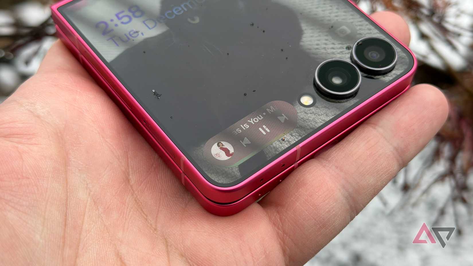 a phone in hand displaying an AR measurement app on a wooden table