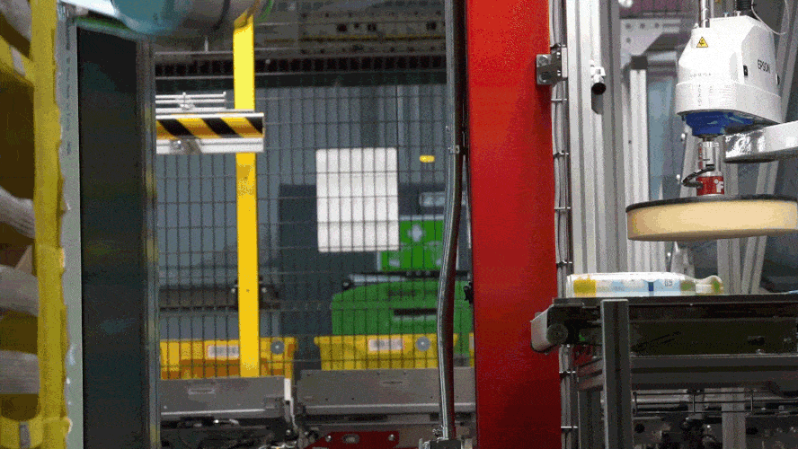 Amazon's Vulcan robot picking up a can of Febreeze. 