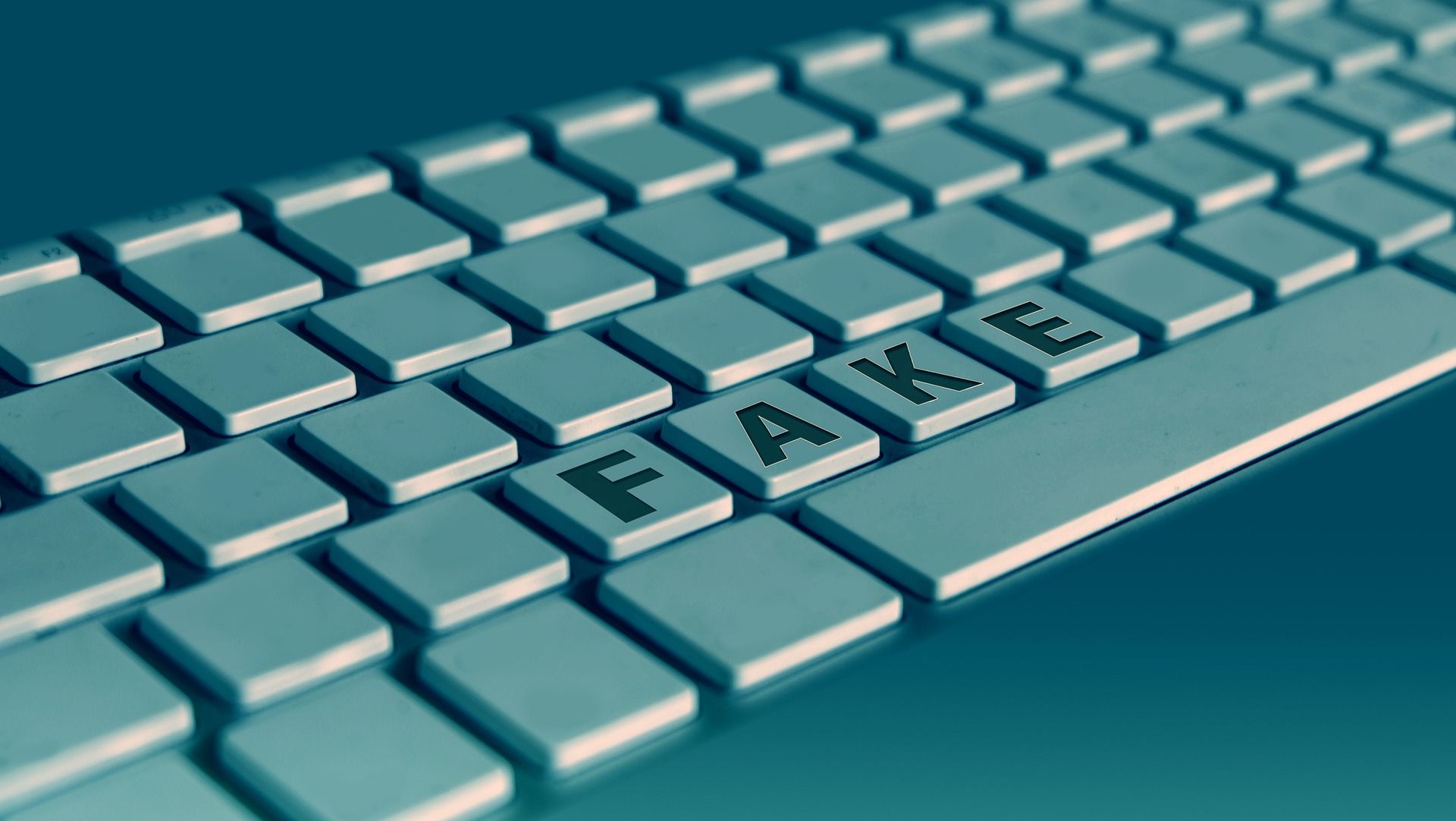 A digital render of a keyboard with a set of keys spelling out 'FAKE'